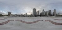 a skateboard park with a lot of ramps and the skyline of los behind it