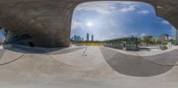 a wide angle shot of a skateboarder in midair over the skateboard area