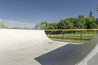 a skateboarder is about to jump into the ramp and then down the slope