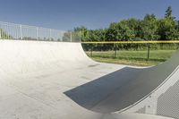 a skateboarder is about to jump into the ramp and then down the slope