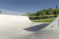 a skateboarder is about to jump into the ramp and then down the slope