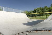 a skateboarder is about to jump into the ramp and then down the slope