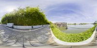 the fish eye view of a skateboard park from underneath the walkway and over the lake