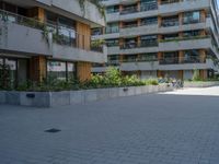 there is a skateboard parked at the edge of the walkway outside of a building