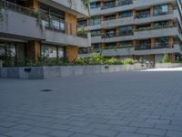 there is a skateboard parked at the edge of the walkway outside of a building