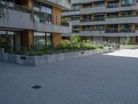 there is a skateboard parked at the edge of the walkway outside of a building