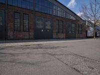 a skateboard is parked on the pavement in front of a building with large windows