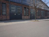 a skateboard is parked on the pavement in front of a building with large windows