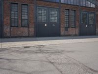 a skateboard is parked on the pavement in front of a building with large windows