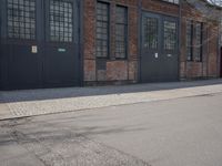 a skateboard is parked on the pavement in front of a building with large windows
