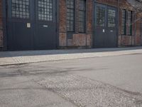 a skateboard is parked on the pavement in front of a building with large windows
