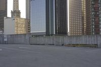 a skateboard is parked on the concrete in front of some tall buildings and some skyscrapers