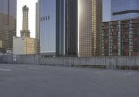 a skateboard is parked on the concrete in front of some tall buildings and some skyscrapers