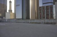 a skateboard is parked on the concrete in front of some tall buildings and some skyscrapers