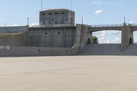 a large skateboard ramp in a concrete building with graffiti on it's side