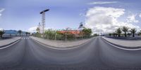 a panorama photo of a man riding on a skateboard next to an asphalt parking lot