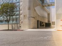 a man riding a skateboard down the side of a road in front of a tall building