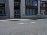 a man on a skateboard is riding down the street by a building with a green sign reading continental