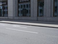 a man on a skateboard is riding down the street by a building with a green sign reading continental