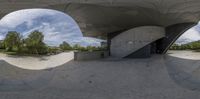 a person riding a skateboard in a half - circular tunnel outside of an underground