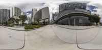 a skateboarder doing tricks in the air over a ramp with buildings in the background