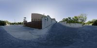 a skateboarder is airborne in the air over a concrete ledge of a half pipe