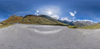 skateboarder skating in road and sky with mountain in background shot from low angle