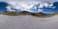 the skateboarder has been riding at the top of a ramp in the mountains