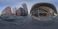 the fisheye effect of the picture shows a skateboarder riding on a half - pipe