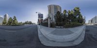 the skateboarder is going up a ramp on his board at an intersection in a city