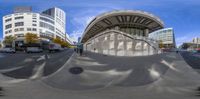 a skateboarder doing tricks on a city sidewalk with other vehicles passing by on both sides