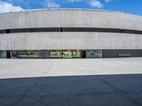 a skateboarder is skating inside of a concrete building with several floors in front