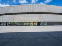 a skateboarder is skating inside of a concrete building with several floors in front