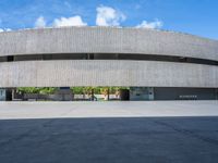 a skateboarder is skating inside of a concrete building with several floors in front