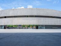 a skateboarder is skating inside of a concrete building with several floors in front