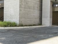 an older skateboarder is taking a leap off an incline ramp in the concrete