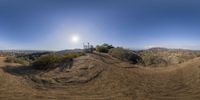 the view of a skateboarder doing a jump in the desert at the park