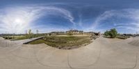 a 360 - view of a skateboarder going down the ramp in an empty park