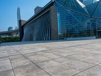 a skateboarder is standing in front of a building with a glass windowed facade