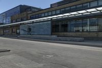 a skateboarder on the street in front of a building in an empty lot