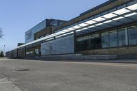 a skateboarder on the street in front of a building in an empty lot