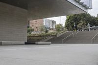 the skateboarder is going up the steps near the building where it stands the other direction