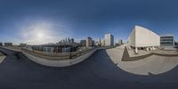 a skateboarder doing tricks on a half pipe in the air next to the city skyline