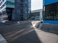 a skateboarder performing a trick in front of an office building with glass walls