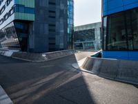 a skateboarder performing a trick in front of an office building with glass walls