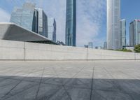 a person on a skateboard rides past some skyscrapers in a cityscape