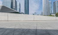 a person on a skateboard rides past some skyscrapers in a cityscape