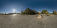 a skateboard riding through an intersection in front of some power lines with a clear sky above