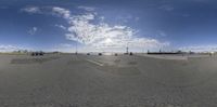 a large wide angle panoramic picture of a skateboarder taking a jump