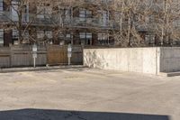 a person is jumping on a skateboard in the air near a parking lot with buildings